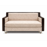 Beige sofa with quilted pattern and dark wooden frame on a white background