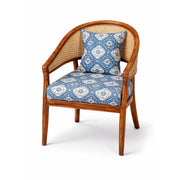 Wooden armchair with blue patterned cushions on a white background