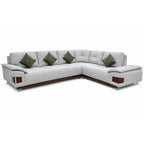 Gray sectional sofa with green cushions on a white background
