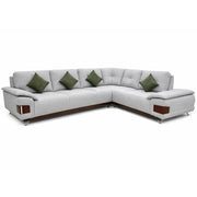 Gray sectional sofa with green cushions on a white background