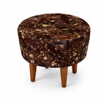 Round ottoman with a patterned brown top and wooden legs on a white background