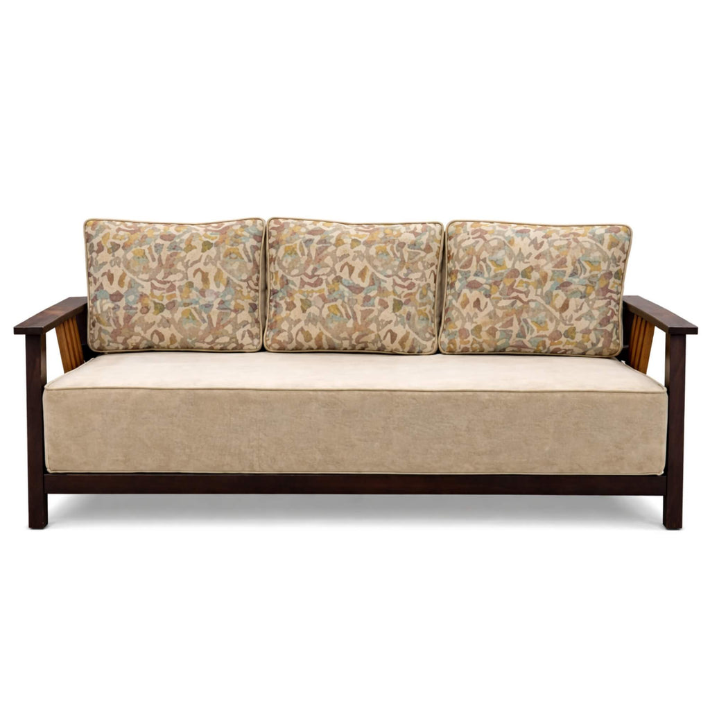 Beige sofa with floral-patterned cushions on a white background