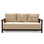 Beige sofa with floral-patterned cushions on a white background