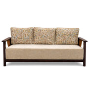 Beige sofa with floral-patterned cushions on a white background