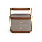 Two-tiered serving cart with wooden accents and gold handles on a white background