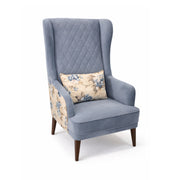 Gray armchair with a floral-patterned pillow on a white background