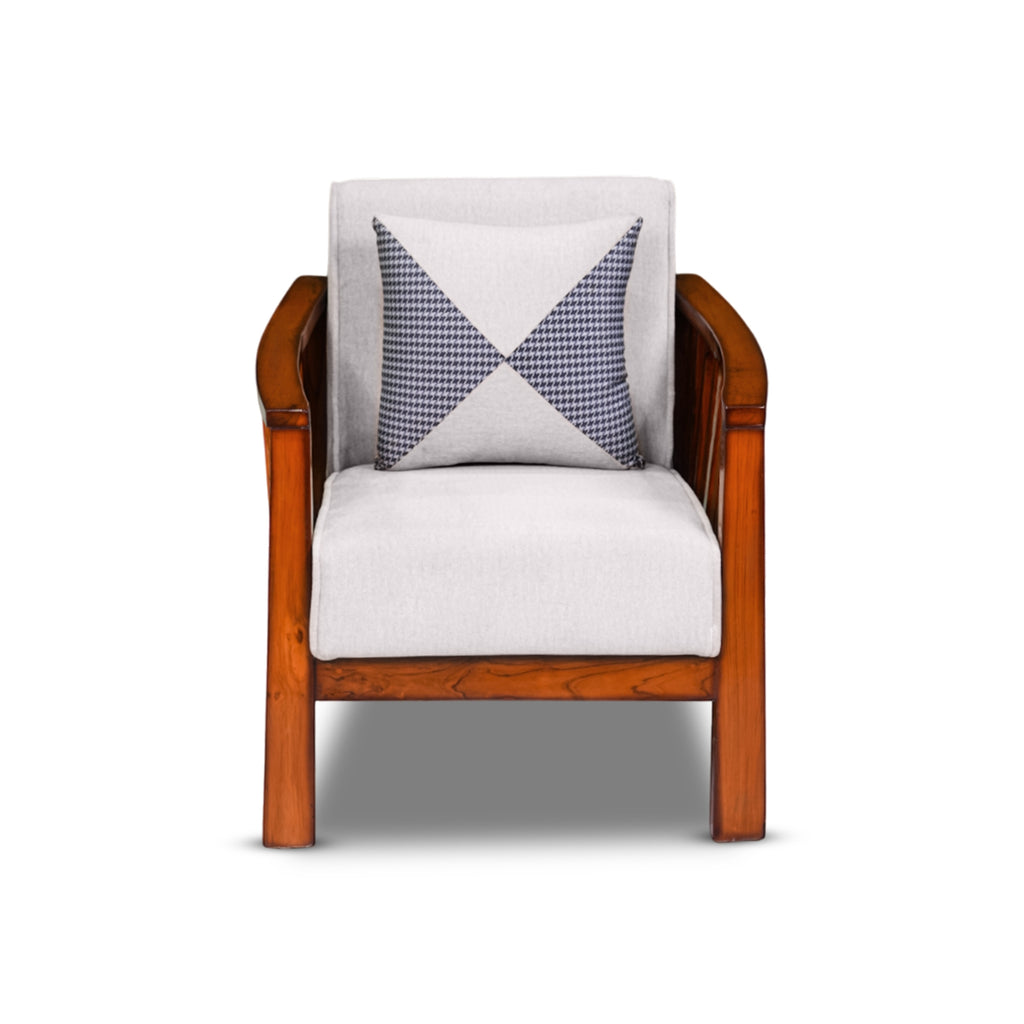Wooden armchair with a white cushion and a patterned blue and white pillow on a white background