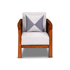 Wooden armchair with a white cushion and a patterned blue and white pillow on a white background