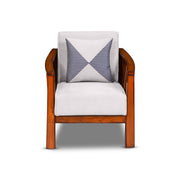 Wooden armchair with a white cushion and a patterned blue and white pillow on a white background
