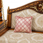 Close-up of check cushion on beige floral bed | qivly:v1:h:b55f6ace20f5c6eff793a41db463548a