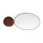White ceramic plate with gold rim and wooden lid on a white background