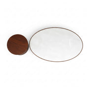 White ceramic plate with gold rim and wooden lid on a white background