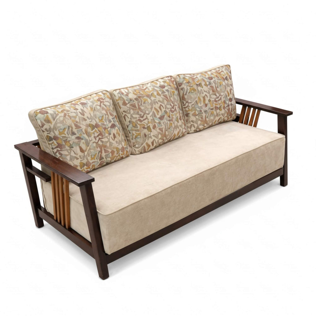 Sofa with patterned backrest cushions and beige seat cushion on a white background