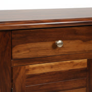 Wooden drawer with a metal handle on a wooden cabinet.