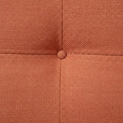 Close-up of a textured brown fabric surface with a button.