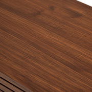 Close-up of a wooden surface with a rich brown color and visible grain.