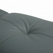 Close-up of a gray cushion with stitching details on a white background