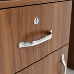 Wooden drawer with metal handle and keyhole