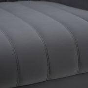 Close-up of a gray upholstered surface with stitching details
