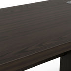 Close-up of a dark wooden desk surface with a white background