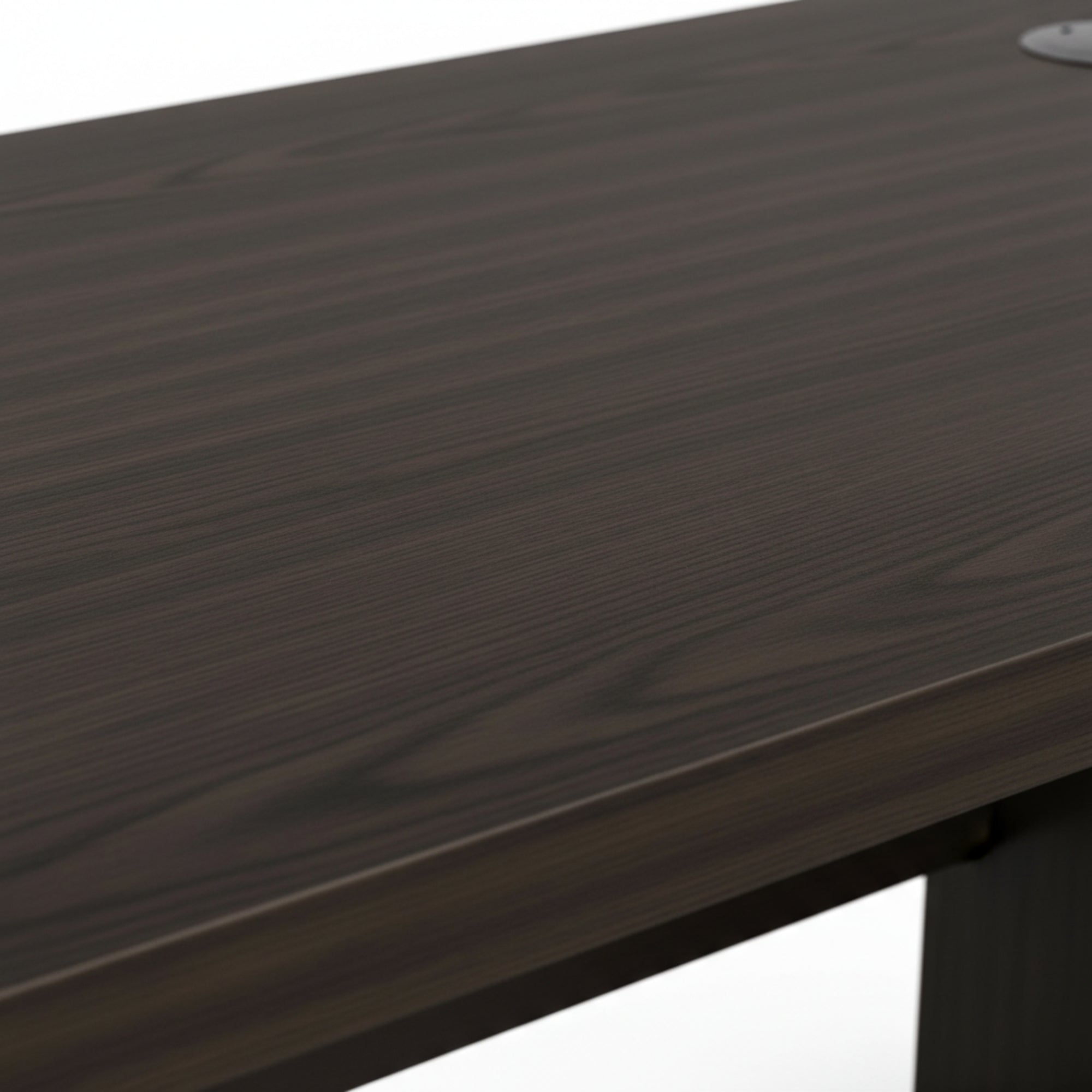 Close-up of a dark wooden desk surface with a white background