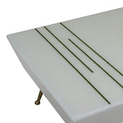Mercy Coffee Table’s clean parallel gold line accents inlaid into the corner of the white tabletop are showcased.