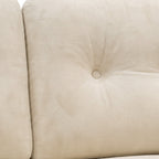 Close-up of a beige upholstered chair with tufted backrest