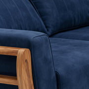 Navy blue sofa with wooden armrests