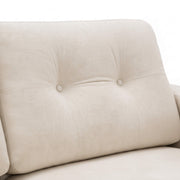 Close-up of a beige upholstered chair with button tufting on a white background