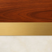 Reno Marble Coffee Table’s layered combination of the brown wood grain, brushed gold trim and off-white marble top is exhibited.