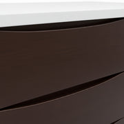 Close-up of a dark brown surface with a white top