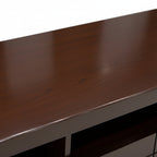 Close-up of a dark wooden surface with a blurred background