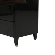 Pacific Dressing Table’s glossy black side panel and the sturdy, tapered support legs of the cabinet's base are highlighted.