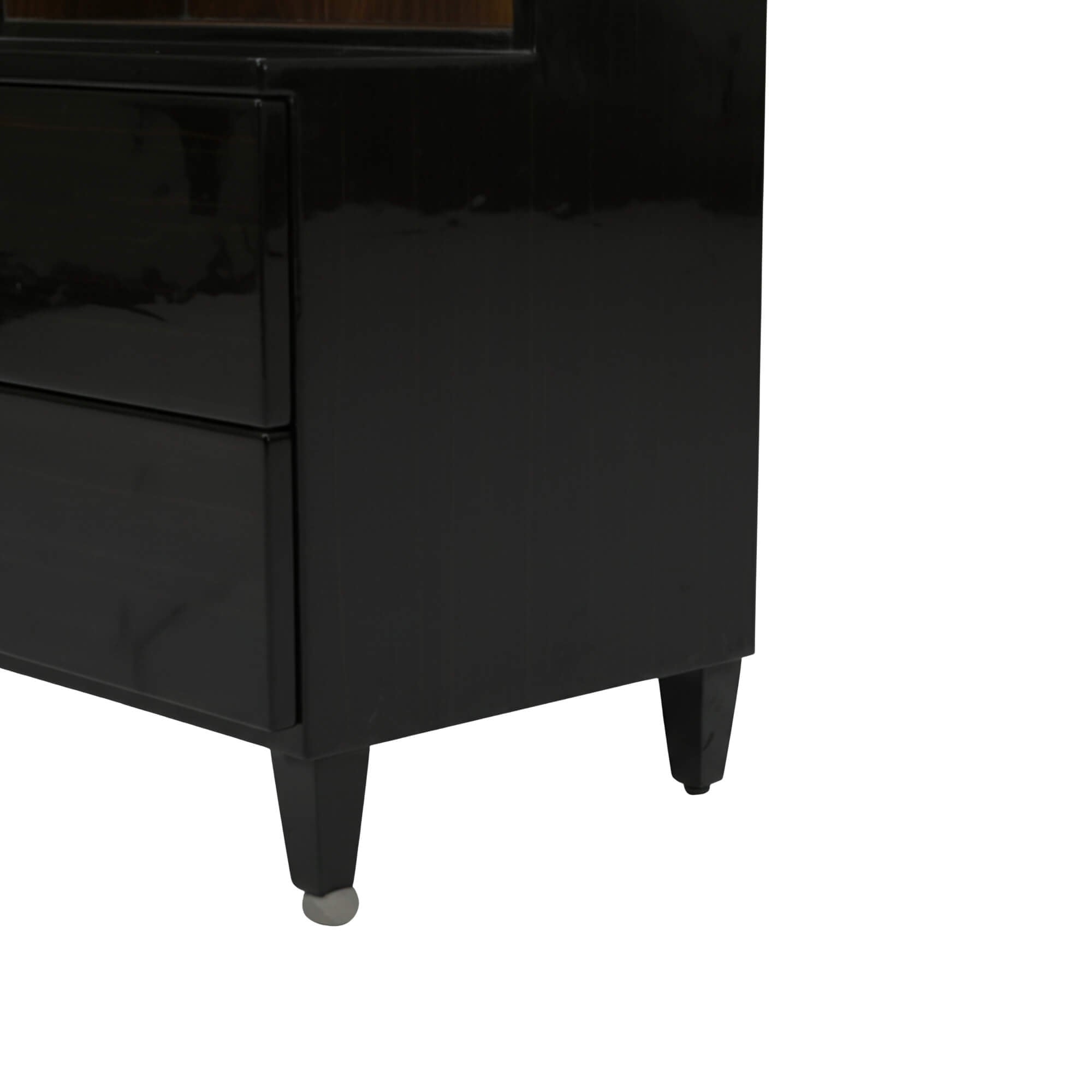 Pacific Dressing Table’s glossy black side panel and the sturdy, tapered support legs of the cabinet's base are highlighted.