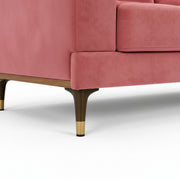 Close-up of a pink sofa with wooden legs on a white background