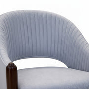 Close-up of a light blue upholstered chair with a ribbed texture on a white background