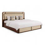 Bed with brown frame and beige headboard on a white background