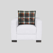 White armchair with a plaid pillow on a light gray background