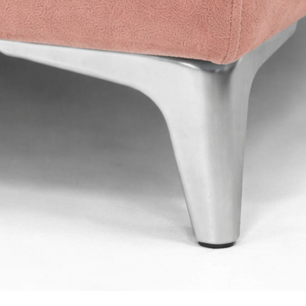 Close-up of a pink chair with a metal leg