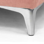 Close-up of a pink chair with a metal leg