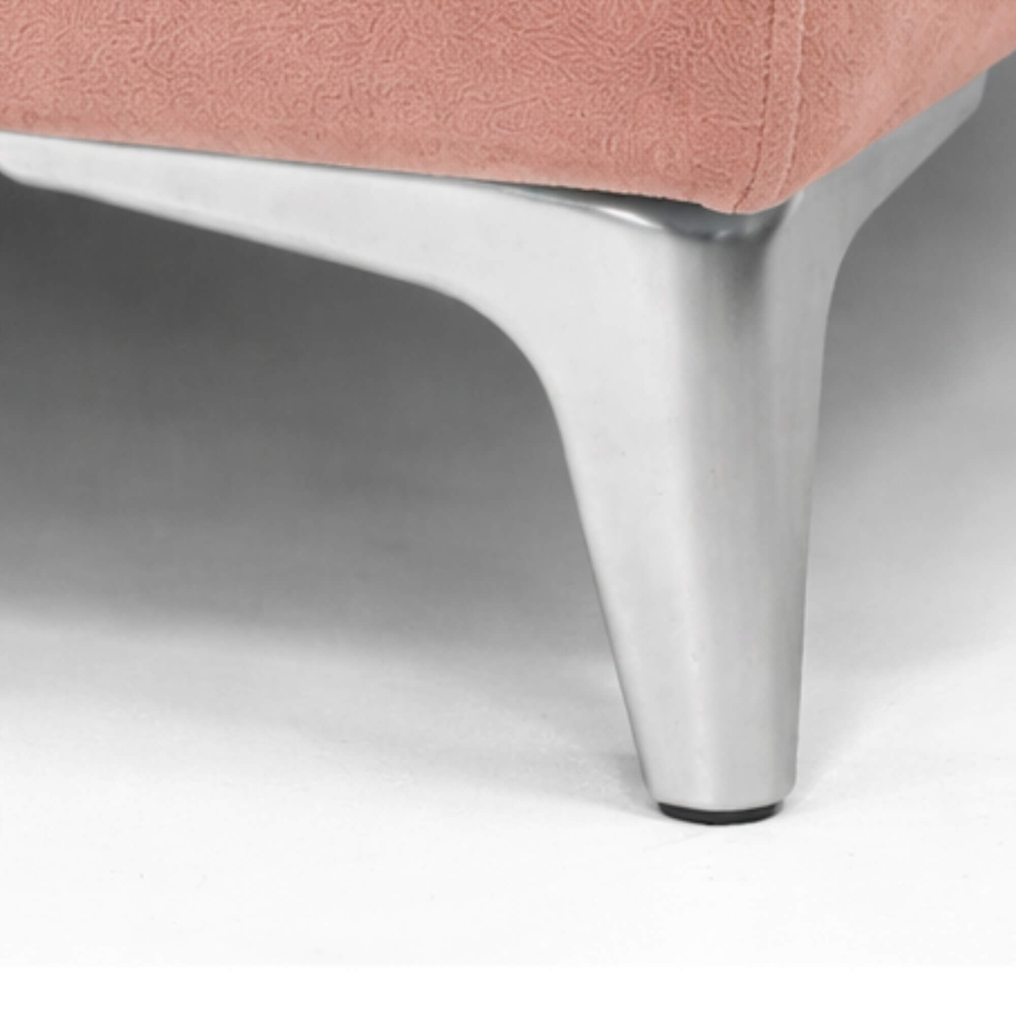 Close-up of a pink chair with a metal leg