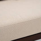 Close-up of a beige upholstered chair with a textured fabric surface.