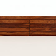 Wooden dresser with four drawers on a white background