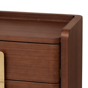 Close-up of a wooden drawer with a gold handle on a white background