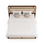 Bed with white bedding and decorative pillows on a white background