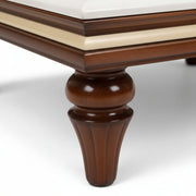 Close-up of a wooden table leg on a white background