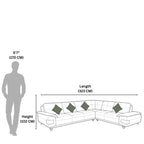 Diagram showing the dimensions of a sectional sofa with a person for scale.