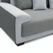 Gray sofa with quilted armrest on a white background