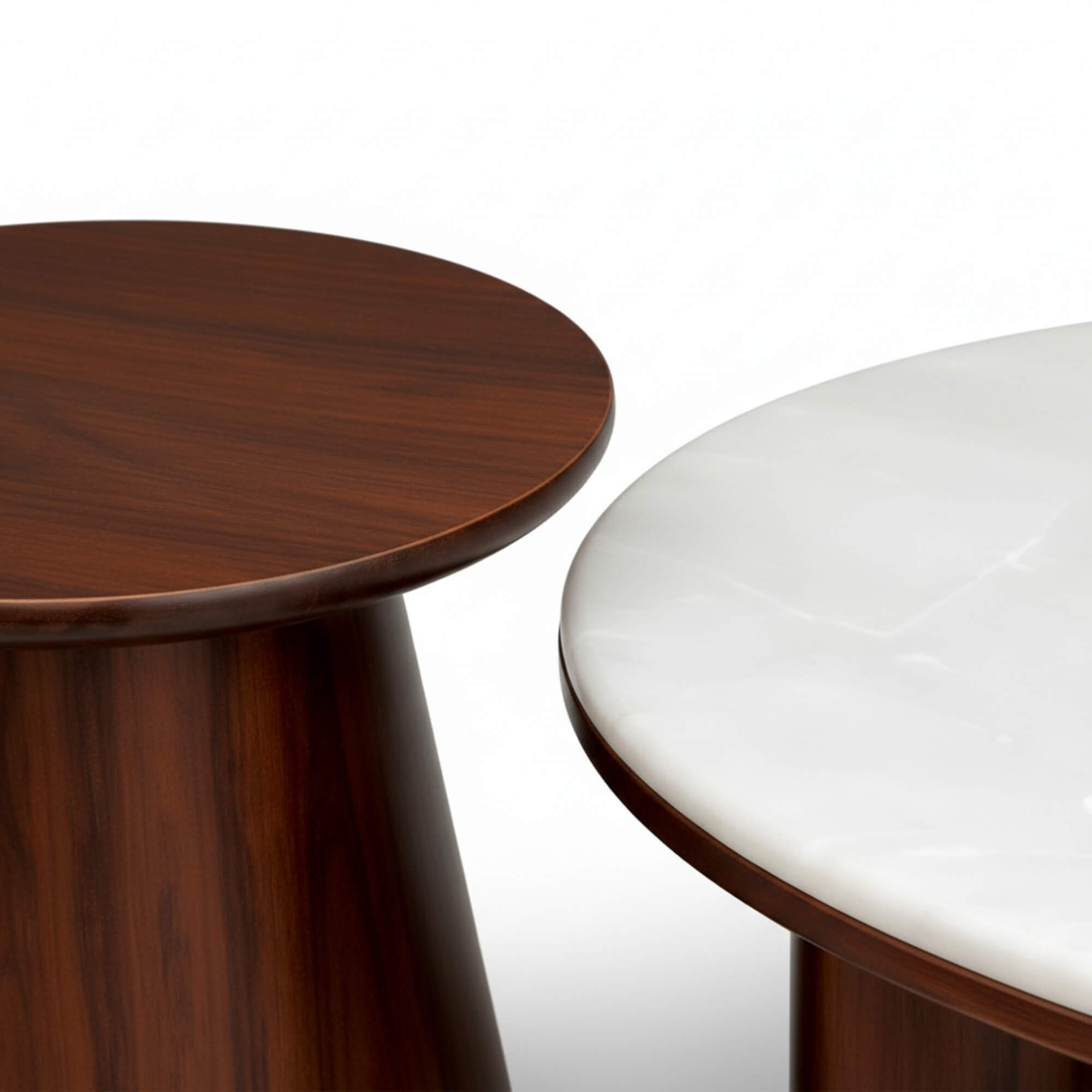 Two round tables, one wooden and one with a white surface, on a white background.