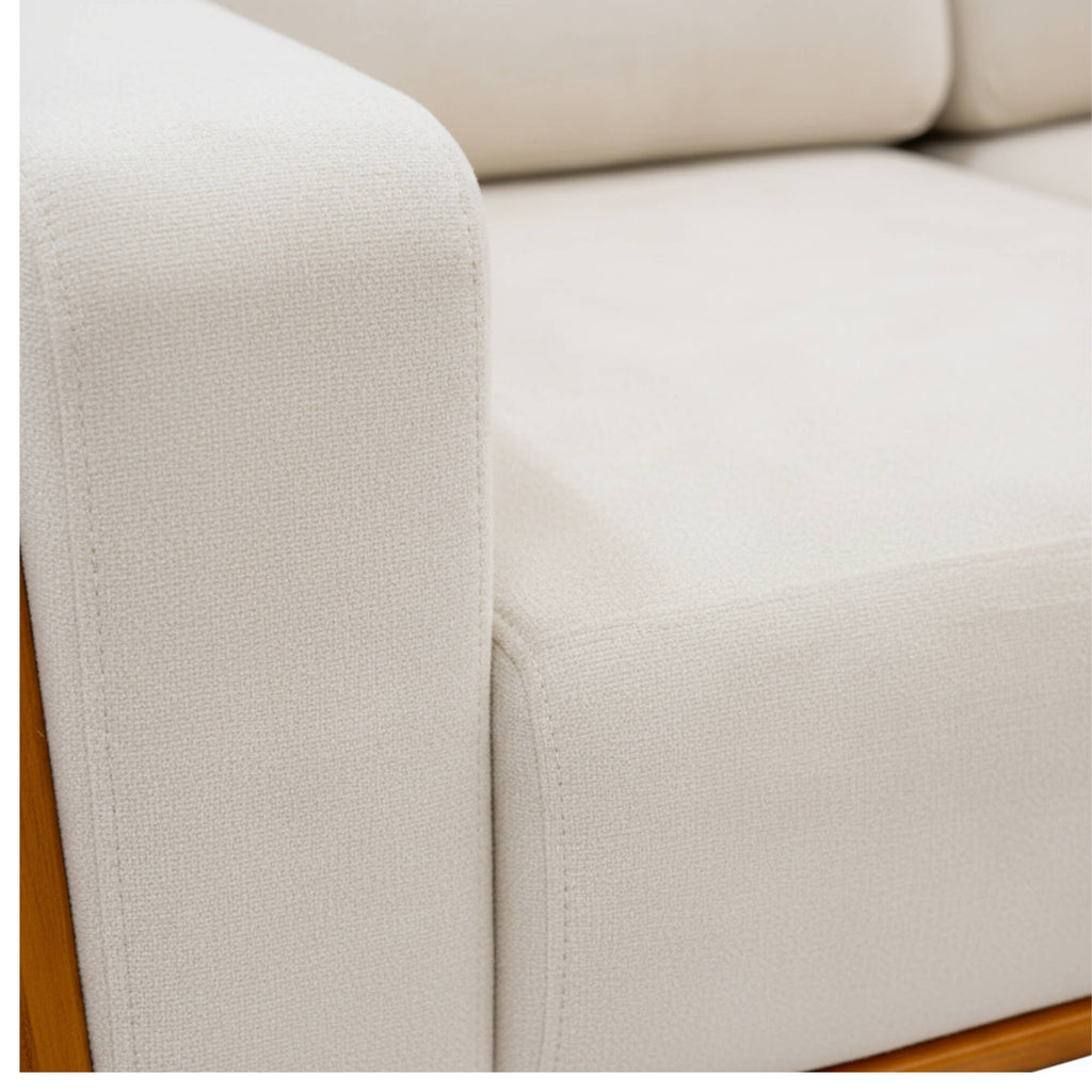 Close-up of a beige sofa with wooden legs on a white background